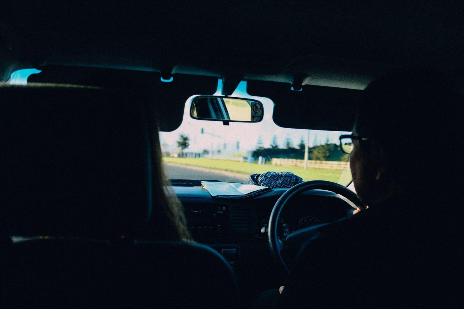 A passenger's view from the back seat of a right-hand-drive car on a coastal road